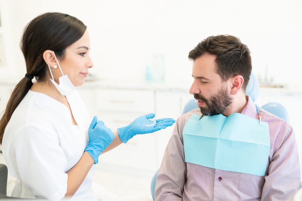 Hombre en el dentista recibe sus alineadores