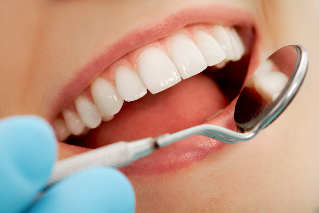 Young woman at the dentist - mistake while brushing her teeth